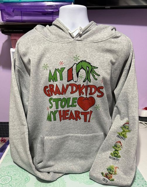 Christmas Grinch sweatshirt with grandkids Stole my heart names on sleeves.